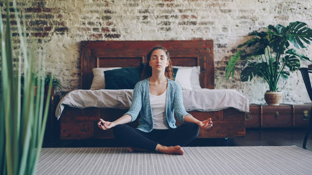 Woman practicing daily mindfulness practice during morning coffee break at home